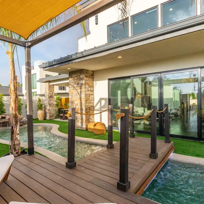 81st residence backyard with pool, wooden deck bridge and covered patio