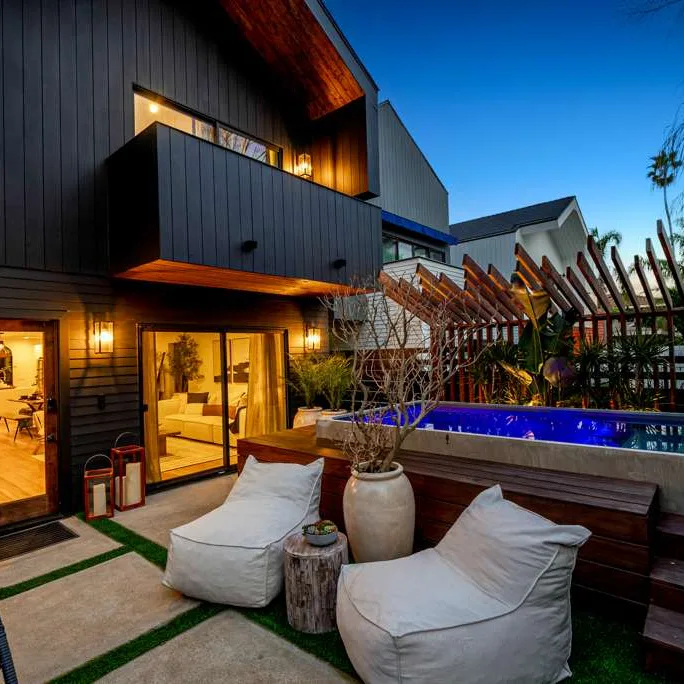 Sequoia residence backyard at dusk with plunge pool and lounge seating